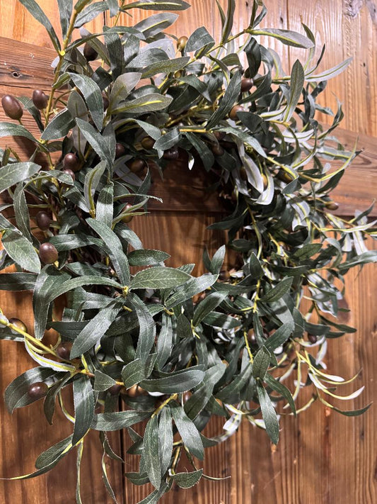 “Handmade olive branch wreath with lush realistic greenery on grapevine base inspired by Tuscany, by Carolyn.”