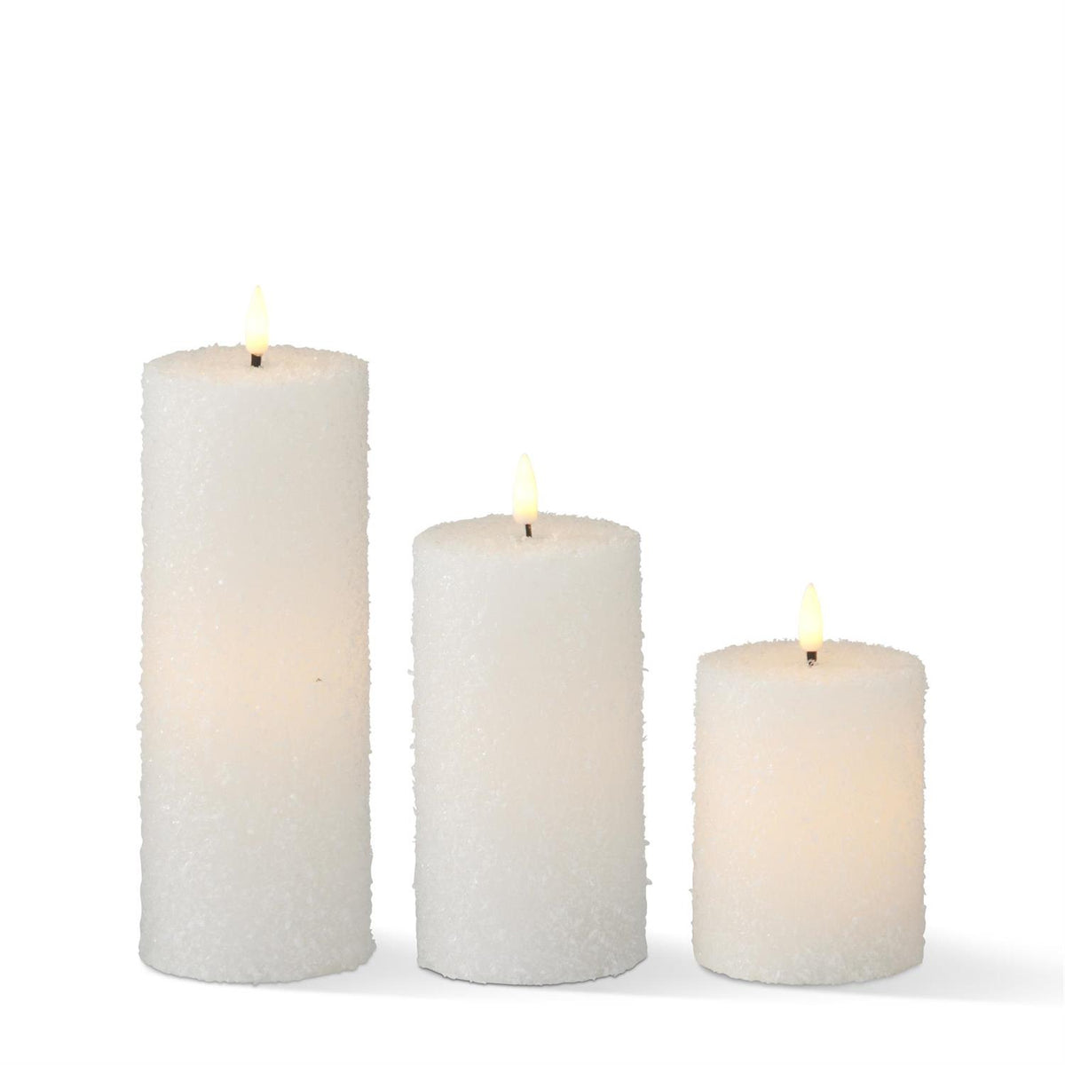 Three white snowy LED pillar candles in graduated heights with textured finishes and glowing flame-shaped lights.