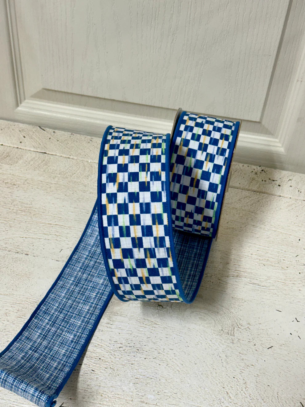 2.5 inch by 10 yard blue and white mini antique check fused ribbon on a spool, perfect for wreaths, bows, and floral crafts"