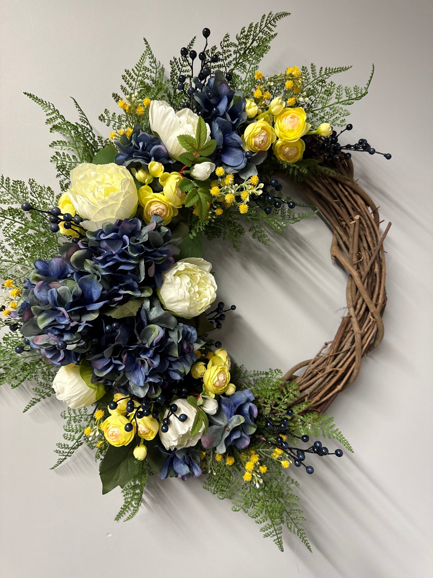 Beautiful handcrafted cottage garden wreath featuring blue ivy and spring florals. Premium quality spring wreath