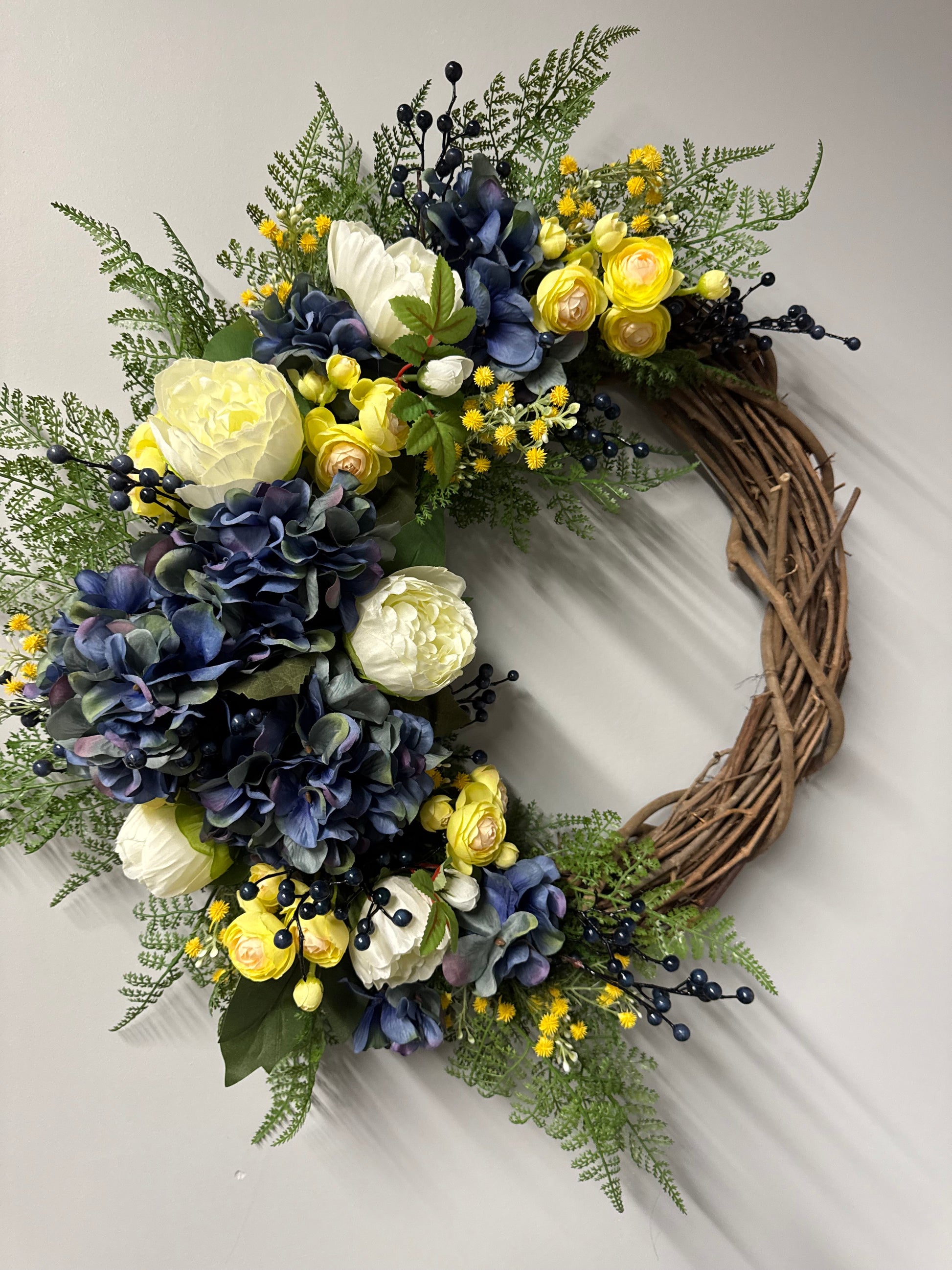 Beautiful handcrafted cottage garden wreath featuring blue ivy and spring florals. Premium quality spring wreath