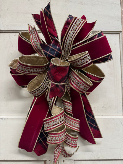 Red plaid and burgundy velvet Christmas bow with gold embroidered ribbon, layered loops, and cascading curled tails.”