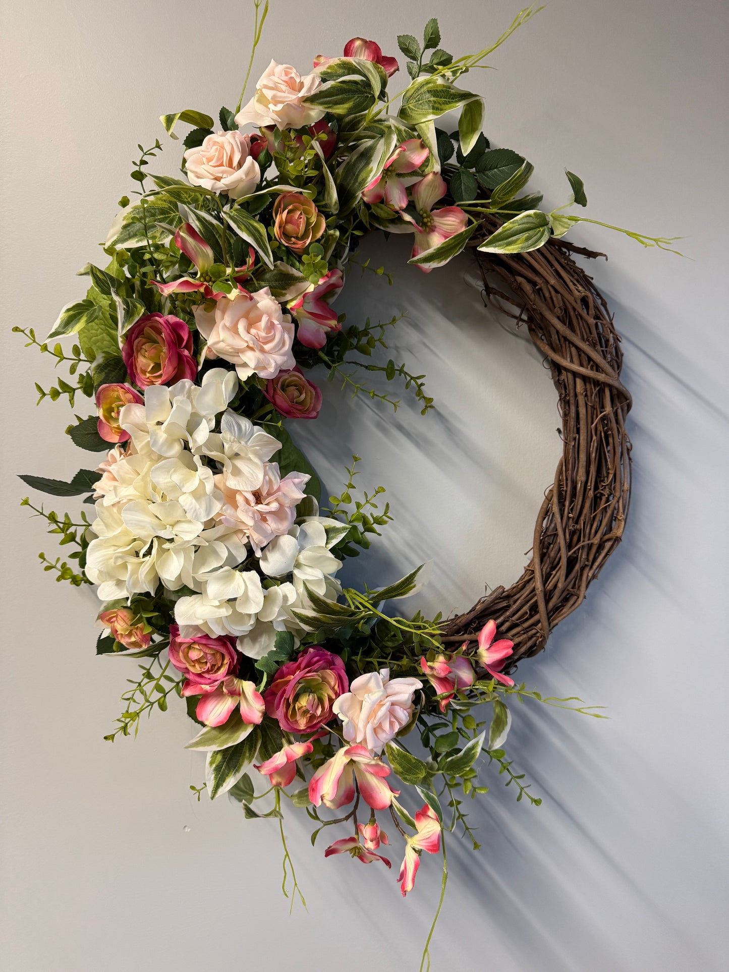 Handcrafted garden romance wreath featuring premium florals and greenery. 