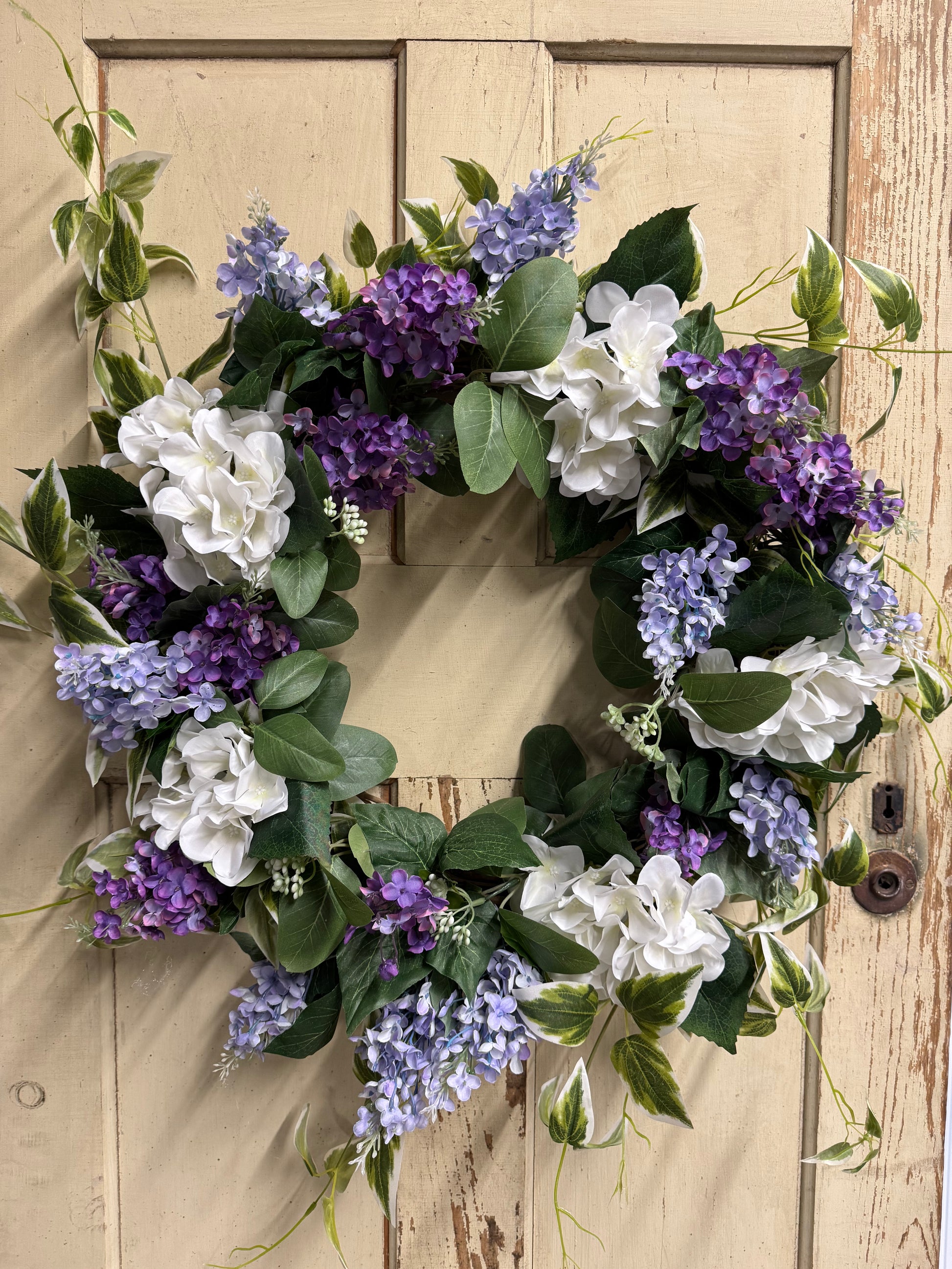 Violet Mae lilac wreath with soft faux purple lilac clusters and lush greenery on a natural base, perfect for front doors and romantic spring-inspired home decor"