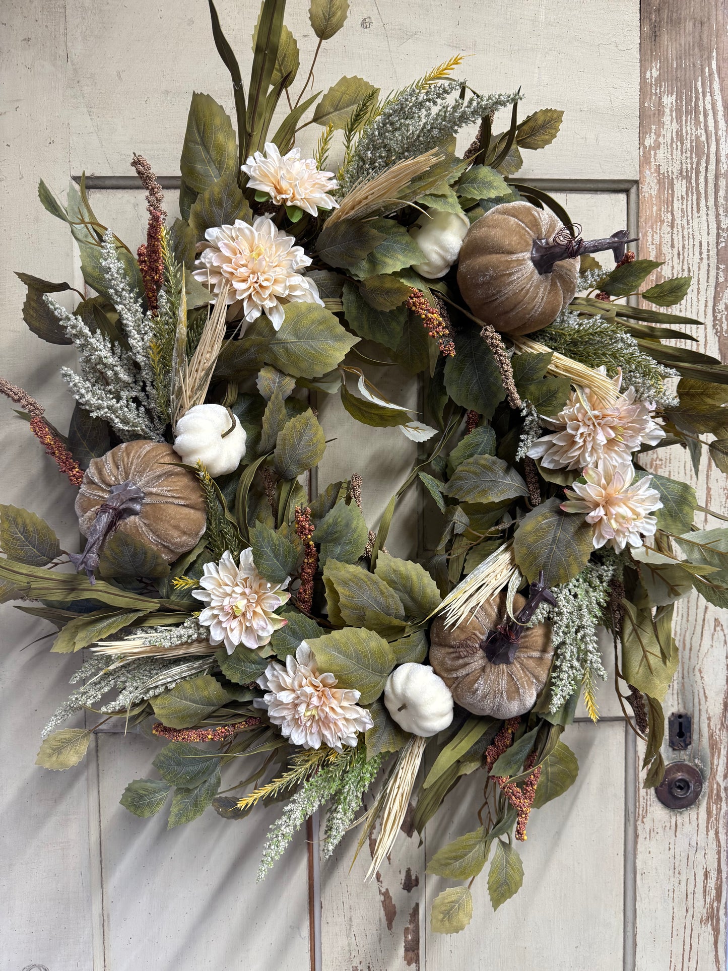 Clara Jane neutral fall wreath with champagne velvet pumpkins, cream dahlias, birch foliage, and wheat accents displayed on a rustic white door"