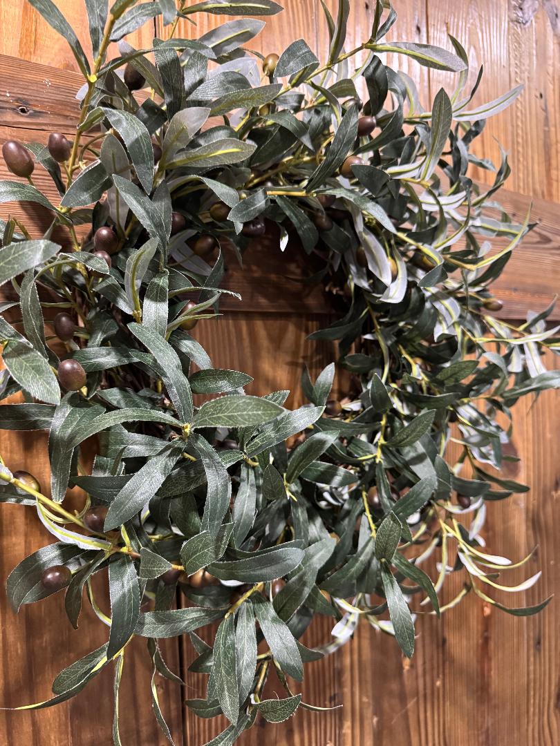 “Handmade olive branch wreath with lush realistic greenery on grapevine base inspired by Tuscany, by Carolyn.”