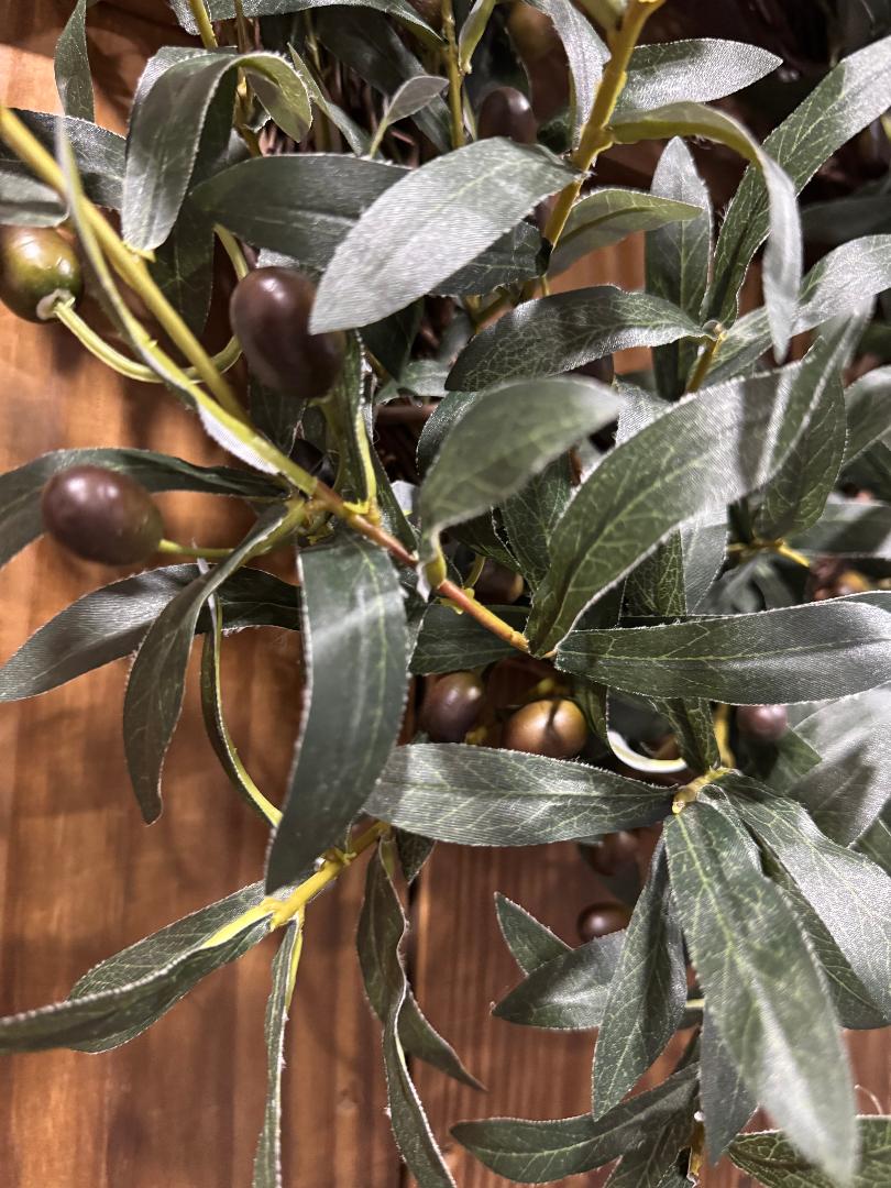 “Handmade olive branch wreath with lush realistic greenery on grapevine base inspired by Tuscany, by Carolyn.”