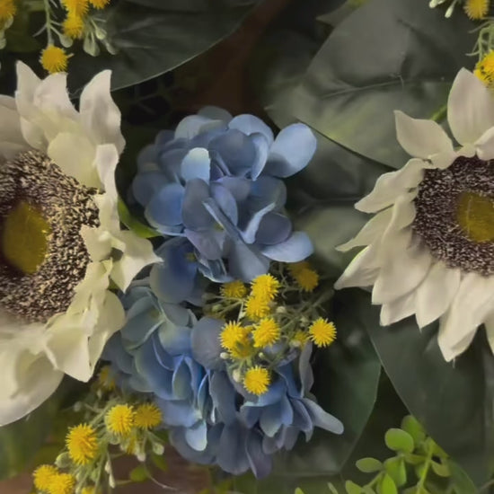 video of Sunny blue hydrangea wreath with white sunflowers and yellow baby's breath on rustic wood frame for front door"