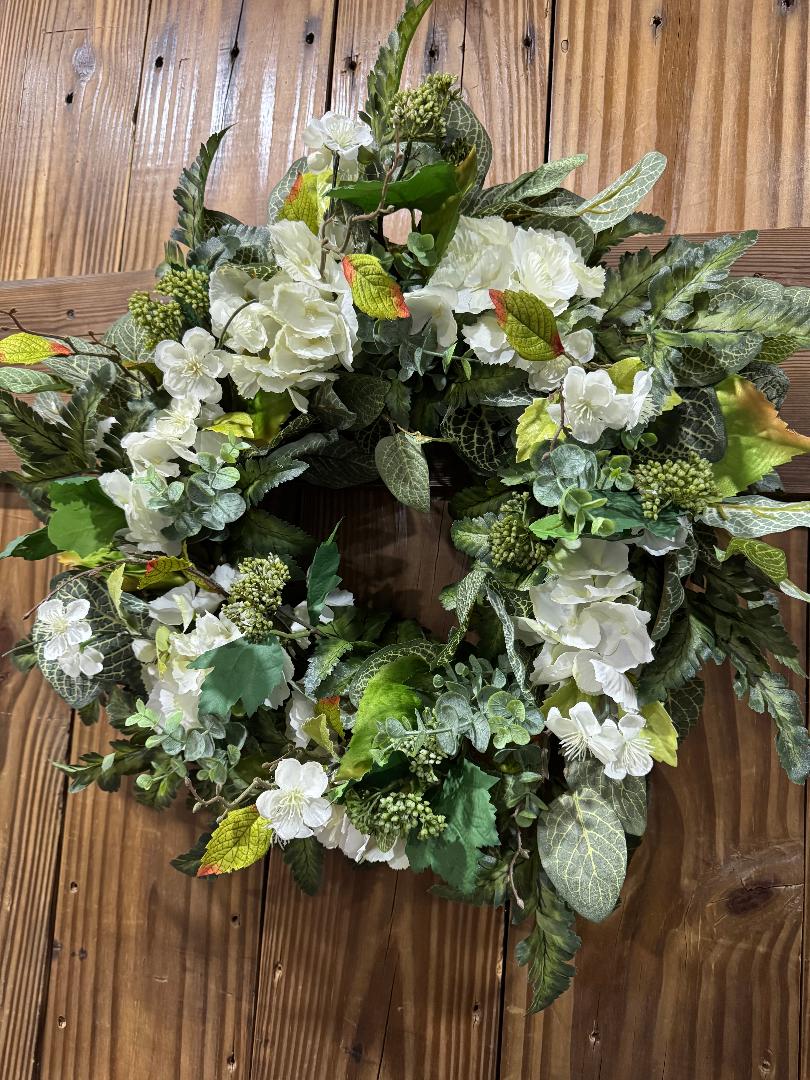 Handmade full green and white hydrangea wreath with ferns and eucalyptus on grapevine base by Carolyn.