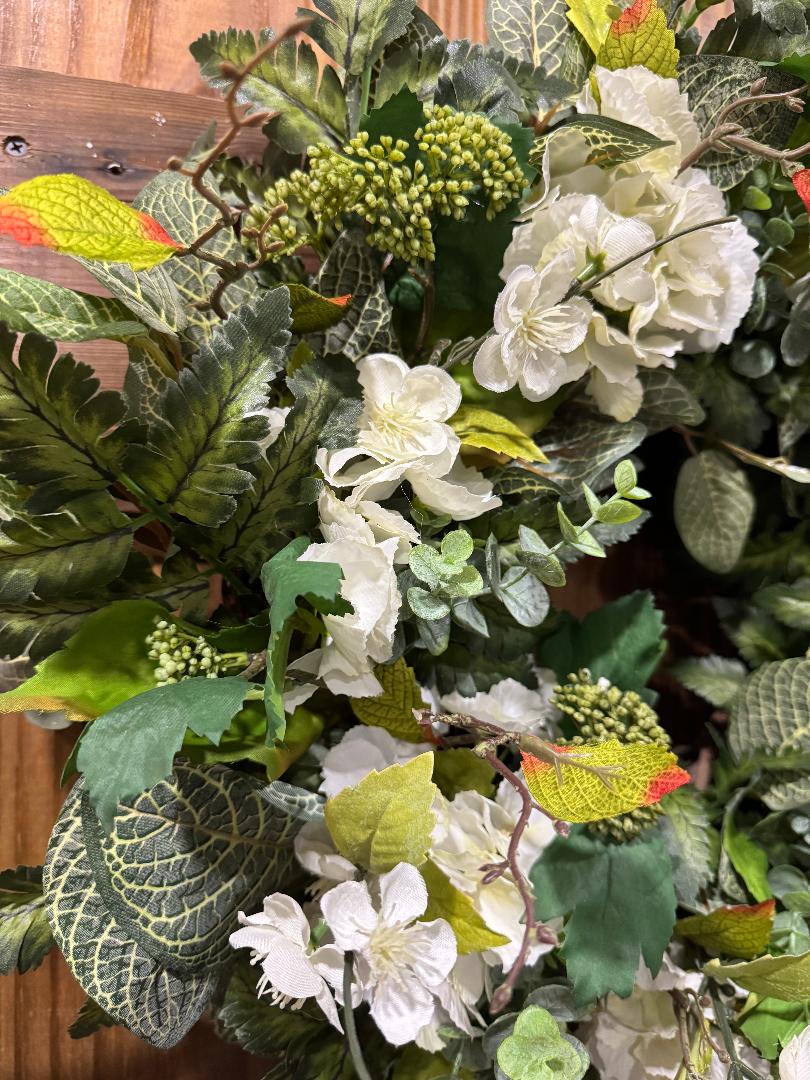 Handmade full green and white hydrangea wreath with ferns and eucalyptus on grapevine base by Carolyn.