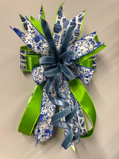 Handcrafted small blue china bow, 14 by 24 inches, made with china pattern, lime green satin, blue floral, and blue velvet ribbon