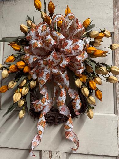 Goldie Glitter Harvest is a handcrafted fall wreath with Chinese lanterns, glitter bow & ribbon on a grapevine base. Made by hand in NH