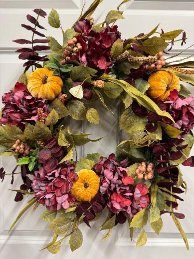 24-inch fall wreath with green birch leaves, burgundy eucalyptus, coral berries, hydrangeas, and a golden velvet pumpkin.”