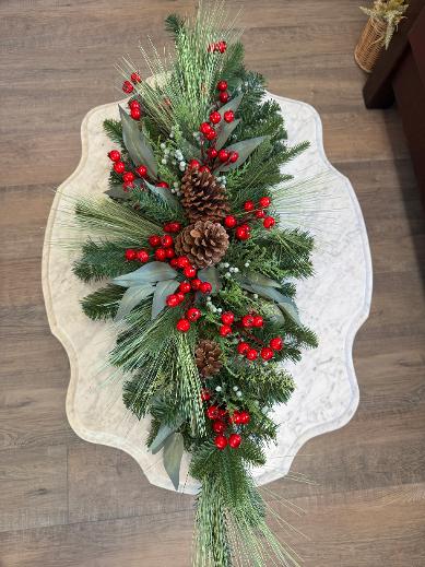 Merry Juniper Christmas centerpiece swag with green pine, juniper berries, bright red berries, eucalyptus, and brown pinecones.”