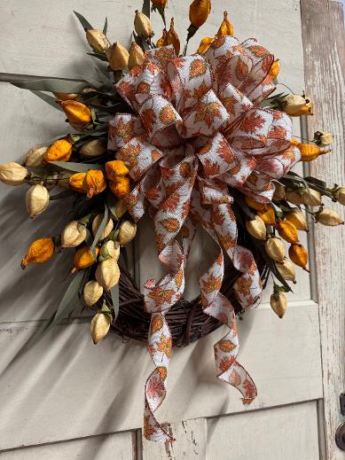 Goldie Glitter Harvest is a handcrafted fall wreath with Chinese lanterns, glitter bow & ribbon on a grapevine base. Made by hand in NH