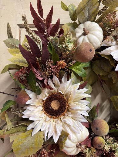 Handcrafted fall wreath with cream sunflowers, ivory pumpkins, flocked pears & burgundy foliage on a 14" grapevine base. Approx. 22" tip to tip.