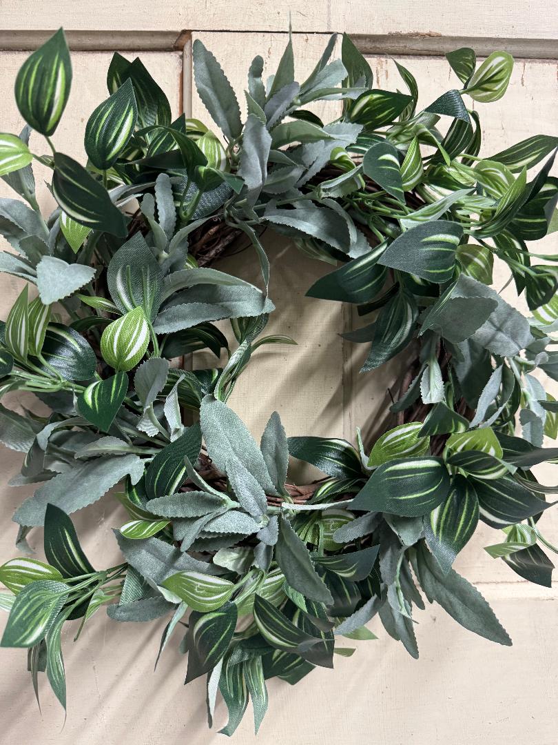 Mixed greenery candle ring with a variety of faux green foliage and leaf textures arranged in a ring, perfect for pillar candles and natural table centerpieces"