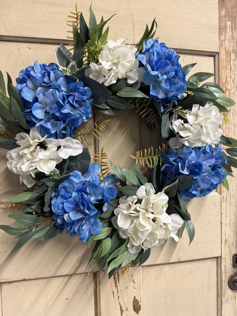 Blue and white hydrangea wreath with lush faux blue and white hydrangea blooms on a natural base, perfect for front doors and home decor"