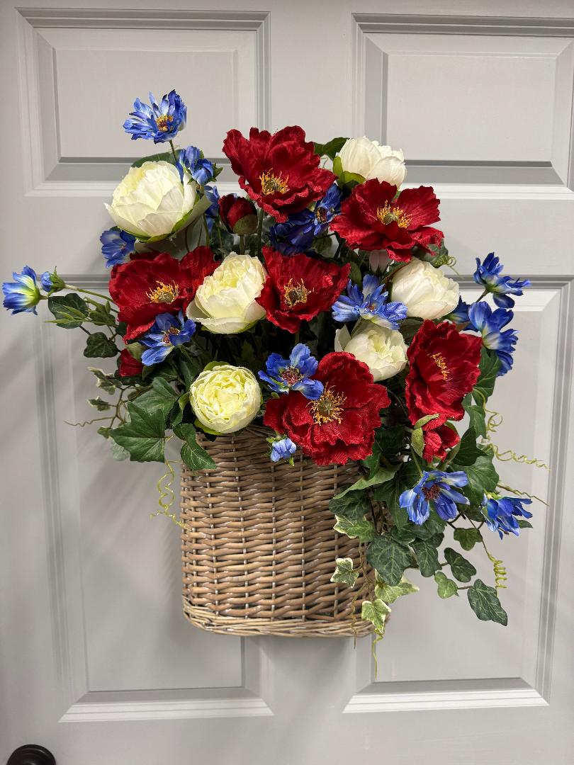 Patriotic basket floral arrangement with red poppies, white peonies, and blue cosmos for a 4th of July wreath making class at The Wreath Room"